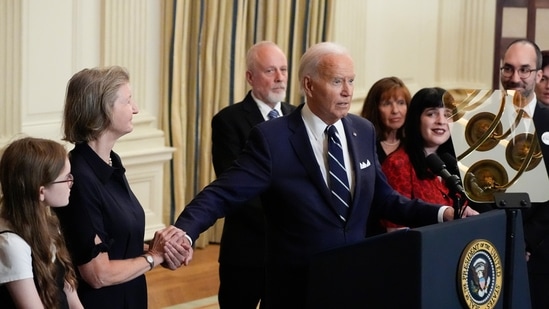 President Joe Biden holds hands with Elizabeth Whelan while delivering remarks on a prisoner swap with Russia from the State Dining Room of the White House, Thursday, Aug. 1, 2024, in Washington, as other hostage family members look on. Whelan's brother, Paul Whelan, was part of the prisoner swap. (AP /Alex Brandon)