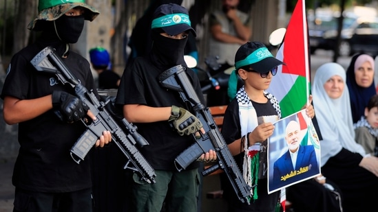 Masked boys hold machine gun toys during a protest in the southern port city of Sidon, Lebanon, Wednesday, July 31, 2024, to condemn the killing of Hamas political chief Ismail Haniyeh.(AP)