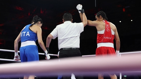 Imane Khelif of Algeria has her hand raised after winning her fight against Angela Carini of Italy