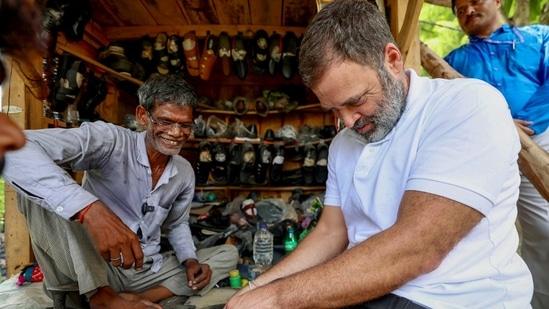 Rahul Gandhi tries his hands at shoe repairing during a short conversation with Ram Chait, a cobbler in Kurebhar near Sultanpur. He met Chait while on his way back to Lucknow from Sultanpur on Friday (ANI)