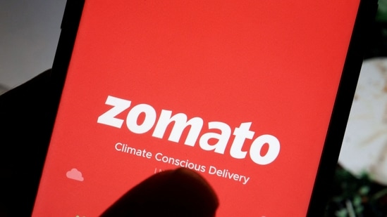 Zomato Q1 results: The logo of Indian food delivery company Zomato is seen on its app on a mobile phone displayed in front of its company website.(REUTERS)