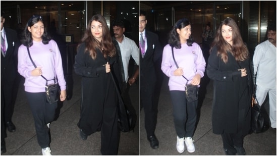 Aishwarya Rai and Aaradhya were clicked at the airport today. For arriving in Mumbai, the actor chose her favourite all-black ensemble. She wore a black long shirt, matching flared pants, and a trench coat. (HT Photo/Varinder Chawla)