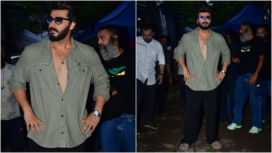 Arjun Kapoor stepped out in Mumbai sporting a casual-chic ensemble. He wore an olive green button-down shirt and black baggy pants for the outing. A watch, quirky sunglasses, a ring, a dainty chain, and slip-on sandals completed the laidback look. (HT Photo/Varinder Chawla)