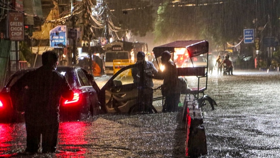 New Delhi: People wade through a waterlogged road during rain at Jangpura area, in New Delhi, Wednesday, July 31, 2024.(PTI)