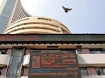 Stock market today: A bird flies past a screen displaying the Sensex results on the facade of the Bombay Stock Exchange (BSE) building in Mumbai.(Reuters)