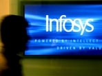 A man walks past a billboard of Infosys Technologies Ltd's office in Bangalore.