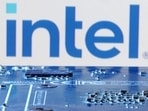 Intel layoffs: Intel logo is seen near computer motherboard.