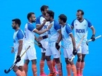 India's Harmanpreet Singh, center, celebrates with teammates after scoring his side's second goal during the men's field hockey match between Australia and India at the Yves-du-Manoir Stadium