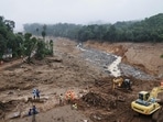 Rescuers search through mud and debris for a third day after landslides set off by torrential rains in Wayanad district. (AP)(HT_PRINT) Rescuers search through mud and debris for a third day after landslides set off by torrential rains in Wayanad district. (AP)(HT_PRINT)