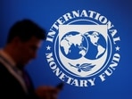 &nbsp;A participant stands near a logo of IMF at the International Monetary Fund - World Bank annual meeting &nbsp;in Nusa Dua, Bali, Indonesia.
