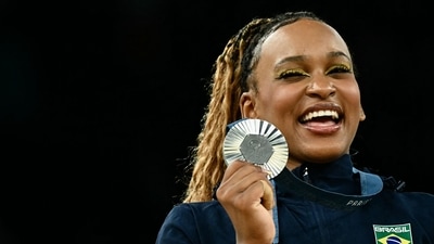 Second-placed Brazil's Rebeca Andrade celebrates during the podium ceremony after the artistic gymnastics women's all around final during the Paris 2024 Olympic Games at the Bercy Arena in Paris (AFP) Second-placed Brazil's Rebeca Andrade celebrates during the podium ceremony after the artistic gymnastics women's all around final during the Paris 2024 Olympic Games at the Bercy Arena in Paris (AFP)