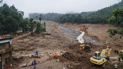 Rescuers search through mud and debris for a third day after landslides set off by torrential rains in Wayanad district. (AP) (HT_PRINT)