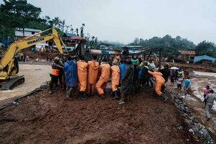 Army soldiers make a bailey bridge as rescuers search through mud and debris for a third day after landslides set off by torrential rains in Wayanad district on August 1. (AP) Army soldiers make a bailey bridge as rescuers search through mud and debris for a third day after landslides set off by torrential rains in Wayanad district on August 1. (AP)