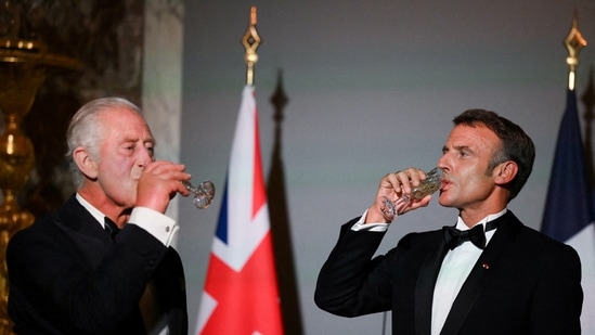 Britain's King Charles and French President Emmanuel Macron drink after a toast during a state banquet at the Palace of Versailles, west of Paris, on September 20, 2023, on the first day of a British royal state visit to France. DANIEL LEAL/Pool via REUTERS/File Photo(via REUTERS)