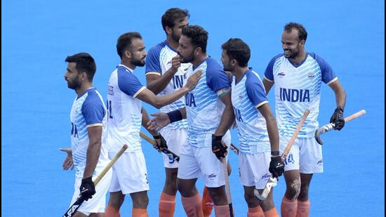 Harmanpreet Singh, centre, celebrates with teammates after scoring his side's second goal against Australia on Friday. (AP)