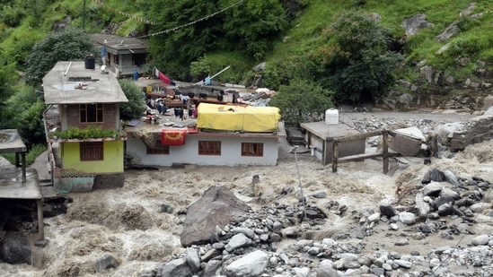 Houses after some part washed away in the river following a flood caused by a cloudburst, at the Baladhi village in Kullu on Thursday. (ANI)(HT_PRINT) Houses after some part washed away in the river following a flood caused by a cloudburst, at the Baladhi village in Kullu on Thursday. (ANI)(HT_PRINT)