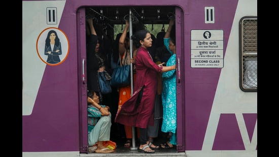 Indian women travel in the ladies compartment of a local train in Mumbai, India, Tuesday, July 23, 2024. (AP Photo/Rafiq Maqbool) (AP)