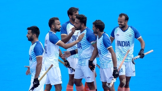 India's Harmanpreet Singh, center, celebrates with teammates after scoring his side's second goal during the men's field hockey match between Australia and India at the Yves-du-Manoir Stadium(AP)