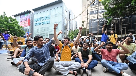 Students protest after three UPSC aspirants were drowned to death after Rau's IAS coaching centres basement library got flooded with rain water following heavy rains on Saturday at Rajendra Nagar in New Delhi. (Photo by Sanchit Khanna/ Hindustan Times)