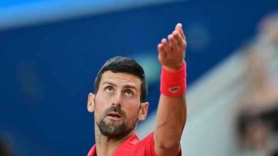 Serbia's Novak Djokovic serves to Italy's Lorenzo Musetti during their men's singles semi-final tennis match on Court Philippe-Chatrier at the Roland-Garros Stadium during the Paris 2024 Olympic Games=(AFP)