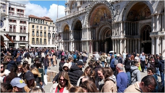 Tourists walk in St Mark's Square on the day Venice municipality introduces a new fee for day-trippers in a move to preserve the lagoon city often crammed with tourists. (Reuters)