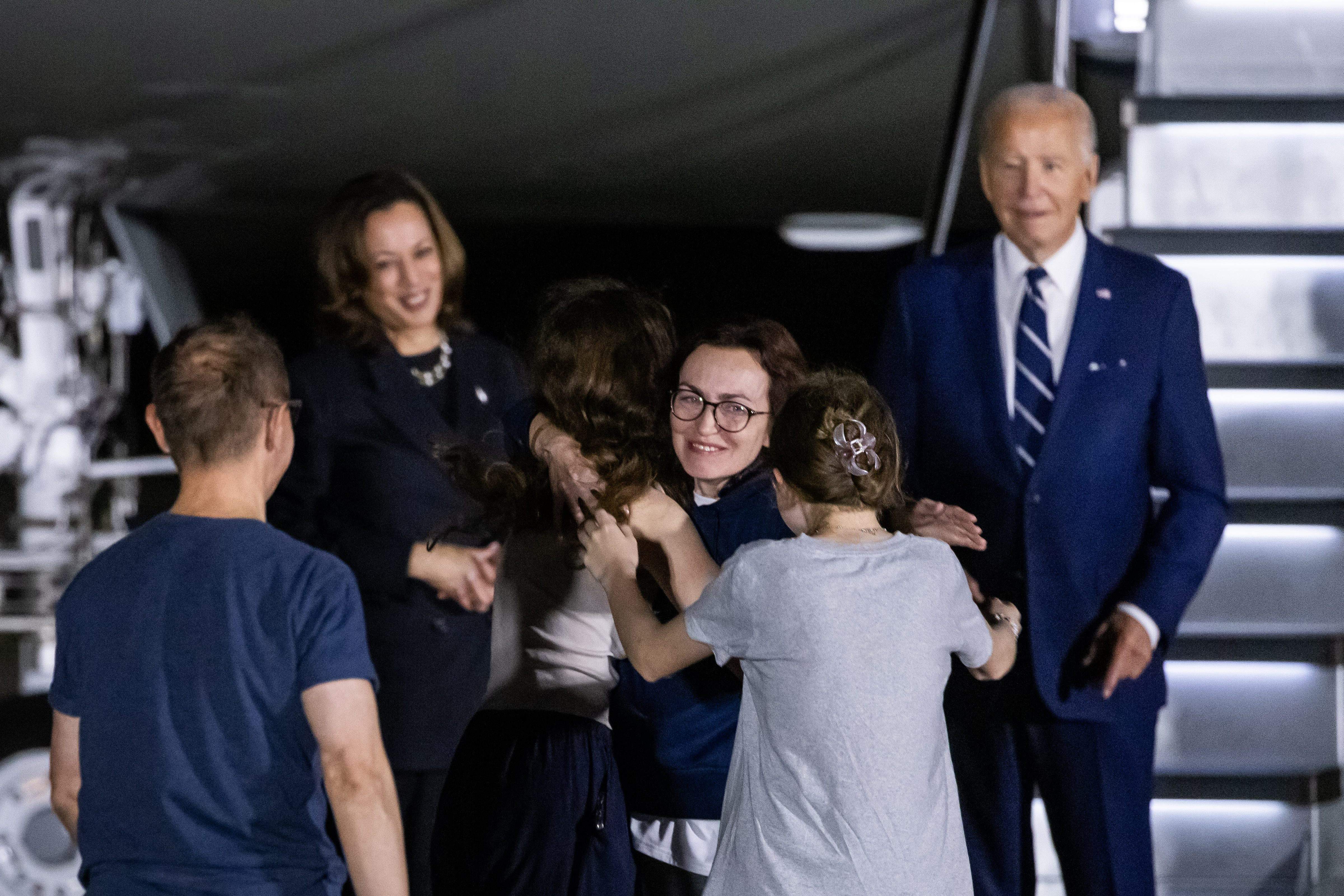 US Presdient Joe Biden (R) and Vice President Kamala Harris (L) react as Russian-American journalist Alsu Kurmasheva (C) hugs her family members after arriving in the US.(PTI)