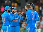 India's Axar Patel (R) celebrates with his captain Rohit Sharma (2L) and teammate Virat Kohli (L) after taking the wicket of Sri Lanka's Janith Liyanage