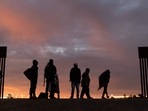 (FILES) Parents-to-be from Haiti stand at a gap in the US-Mexico border wall after having travelled from South America to the United States, in Yuma, Arizona, on December 10, 2021. (FILES) Parents-to-be from Haiti stand at a gap in the US-Mexico border wall after having travelled from South America to the United States, in Yuma, Arizona, on December 10, 2021.