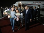 The image shows Russian President Vladimir Putin with one of the kids of the two Russian sleeper agents who were flown to Moscow. 