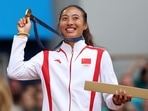 Gold medallist Qinwen Zheng of China poses with her medal.