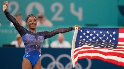 Simone Biles, of the United States, celebrates after winning the gold medal during the women's artistic gymnastics all-around finals in Bercy Arena at the 2024 Summer Olympics, Thursday, Aug. 1, 2024, in Paris, France. (AP) Simone Biles, of the United States, celebrates after winning the gold medal during the women's artistic gymnastics all-around finals in Bercy Arena at the 2024 Summer Olympics, Thursday, Aug. 1, 2024, in Paris, France. (AP)