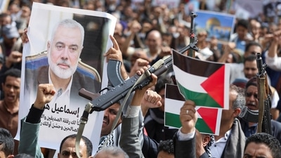 A protester holds up a poster of assassinated Hamas chief Ismail Haniyeh during a protest to show solidarity with Palestinian prisoners, outside the United Nations offices in Sanaa, Yemen, August 3, 2024. (Reuters)