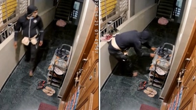 The image shows a man stealing shoes from a rack kept in the corridor of a building in Bengaluru. (Screengrab) The image shows a man stealing shoes from a rack kept in the corridor of a building in Bengaluru. (Screengrab)