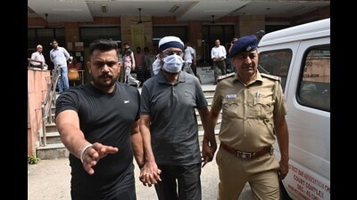 Retired assistant inspector general (AIG) Malvinder Singh Sidhu in police custody. (Ravi Kumar/HT) Retired assistant inspector general (AIG) Malvinder Singh Sidhu in police custody. (Ravi Kumar/HT)