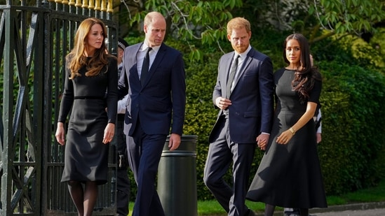 FILE - Britain's Prince William, second left, Kate, Princess of Wales, left, Britain's Prince Harry, second right, and Meghan, Duchess of Sussex view the floral tributes for the late Queen Elizabeth II outside Windsor Castle, in Windsor, England on Sept. 10, 2022. (AP Photo/Martin Meissner, File)(AP)