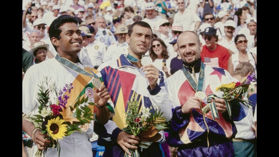 Gold medalist Andre Agassi (R) from the United States celebrates on the winners podium with silver medalist Sergi Bruguera (C) of Spain and bronze medalist Leander Paes of India following the Men's Singles Final match at the XXVI Summer Olympic Games on 3rd August 1996 at the Stone Mountain Tennis Center in Stone Mountain, Georgia, United States. (Photo by Gary M. Prior/Allsport/Getty Images) (Getty Images)