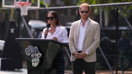 Meghan Markle, left, speaks next to her husband Prince Harry, right, during, the Giant of Africa Foundation at the Dream Big Basketball clinic in Lagos Nigeria, Sunday, May 12, 2024. (AP Photo/Sunday Alamba)(AP)