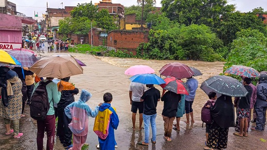 Rain Today Live Updates: Locals watch rainwaters flowing on a road in a flood-affected area after heavy rains, in Ranchi, Friday, Aug. 2, 2024. (PTI Photo) 