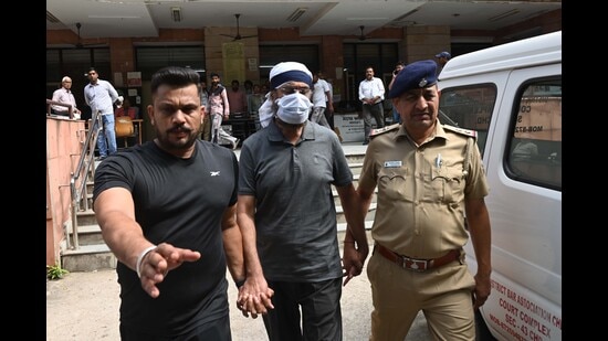 Retired assistant inspector general (AIG) Malvinder Singh Sidhu in police custody. (Ravi Kumar/HT)