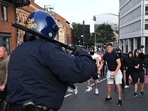 Riot police face protestors in Bristol, southern England, on August 3, 2024 during the 'Enough is Enough' demonstration held in reaction to the fatal stabbings in Southport on July 29. (Photo by JUSTIN TALLIS / AFP)(AFP)