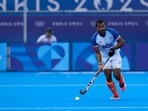 India's Amit Rohidas drives the ball during the men's quarterfinal field hockey match between Britain and India at the Yves-du-Manoir Stadium