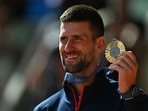 Gold medallist, Serbia's Novak Djokovic poses with his medal on the podium at the presentation ceremony for the men's singles tennis event on Court Philippe-Chatrier Gold medallist, Serbia's Novak Djokovic poses with his medal on the podium at the presentation ceremony for the men's singles tennis event on Court Philippe-Chatrier