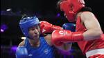 China's Li Qian, right, fights India's Lovlina Borgohain in their 75 kg quarter-final at the Paris Olympics on Sunday. (AP) China's Li Qian, right, fights India's Lovlina Borgohain in their 75 kg quarter-final at the Paris Olympics on Sunday. (AP)