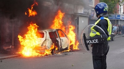 A car burns on Parliament Road during an anti-immigration protest in Middlesbrough, England on August 4, 2024. (AP) A car burns on Parliament Road during an anti-immigration protest in Middlesbrough, England on August 4, 2024. (AP)