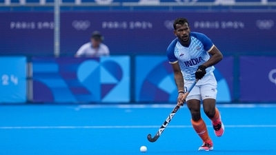 India's Amit Rohidas drives the ball during the men's quarterfinal field hockey match between Britain and India at the Yves-du-Manoir Stadium (AP) India's Amit Rohidas drives the ball during the men's quarterfinal field hockey match between Britain and India at the Yves-du-Manoir Stadium (AP)