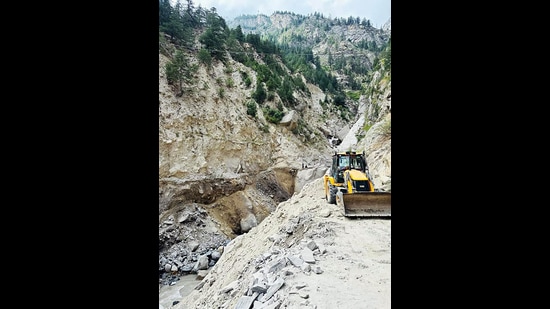A JCB machine works for the restoration of a road that got damaged due to heavy rain following a cloudburst, at Rispa village in Kinnaur on Sunday. (ANI)