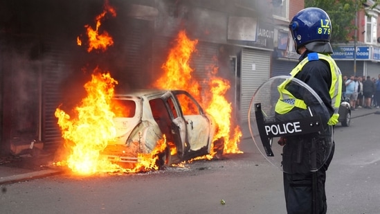 A car burns on Parliament Road during an anti-immigration protest in Middlesbrough, England on August 4, 2024.(AP)