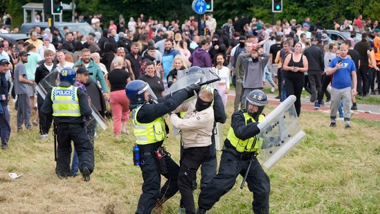 Police officers grapple with a man during an anti-immigration demonstration outside the Holiday Inn Express in Rotherham, England, Sunday Aug. 4, 2024.(AP)