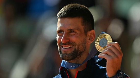 Gold medallist, Serbia's Novak Djokovic poses with his medal on the podium at the presentation ceremony for the men's singles tennis event on Court Philippe-Chatrier(AFP)