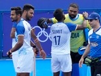 India's Harmanpreet Singh, second left, reacts as he celebrates with teammates after their win in the men's quarterfinal field hockey match against Britain